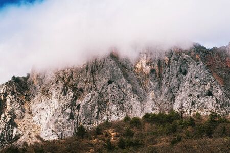 High cliffs in foggy weather during the dayの写真素材