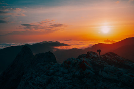 Beautiful golden sunset in the mountains in the fog.の写真素材