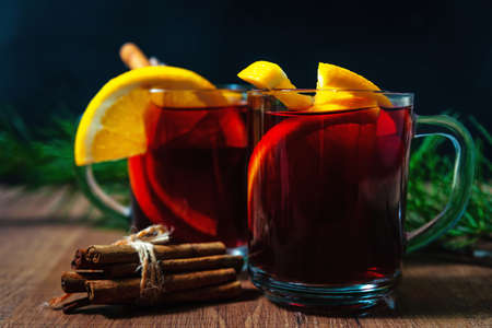 Mulled wine with aromatic spices on a wooden backgroundの写真素材