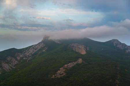 Tent in the mountains near a campfire on a hike in a tourist camp, activity, rest, relaxation, silenceの写真素材