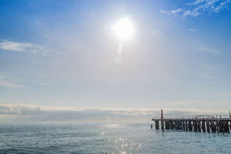 Sunset at the seaside, blue sea, crimson skyの写真素材