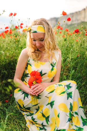 Girl in a toga with a basket of grapes in the vineyardの写真素材