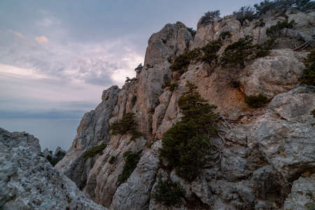 Rocky mountain range in the daytime in the fog above the clouds. Battlements of Mount Ai-Petri, Yalta, southern coast of Crimeaの写真素材