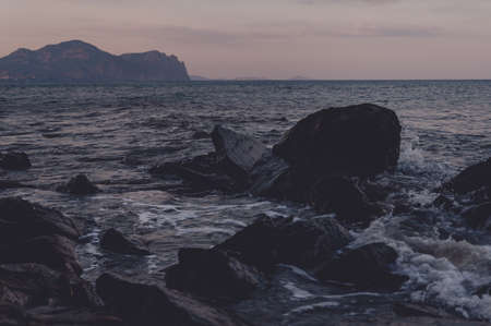 Evening seascape in cold blue tones on the rocky coastの写真素材