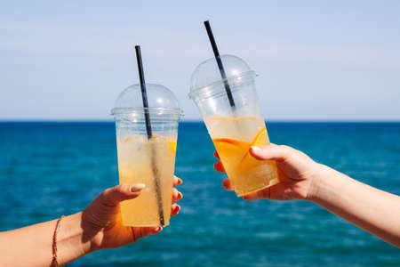 Cold lemonade on the background of the blue sea on a summer sunny dayの写真素材