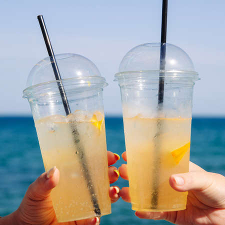 Cold lemonade on the background of the blue sea on a summer sunny dayの写真素材
