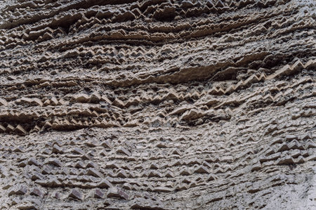 Rocky textured gray clay mountains, natural backgroundの写真素材