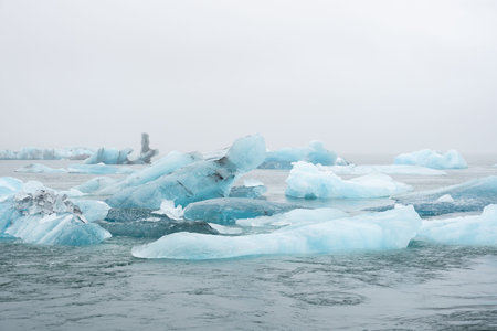Iceland Lake with Melting Glaciers in Foggy Weather, Pure Blue Ice in Jokulsarlon lagoon.