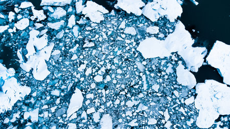 Melting Arctic ice in ocean water. Snow covered Blue glacier ice in Iceland. Global warming and...