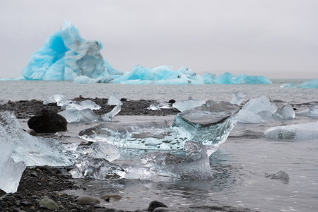 Blue Icebergs in Ocean Water. Glacier Ice Drift at Calm Water. Pure Ice Chunks from Melting Glacier....