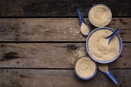 Quinoa in bowls on wooden table