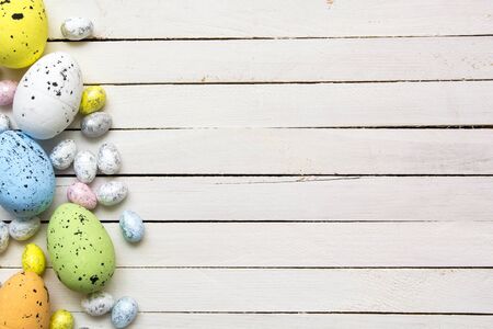 Easter eggs on white wooden background.の写真素材
