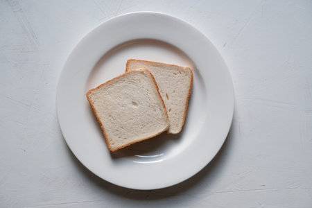 Sliced toast bread isolated on the white plate