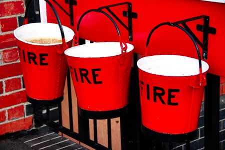 Old red fire buckets at train stationの写真素材