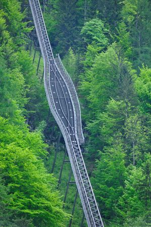 funicular leading up hill through the forestの写真素材