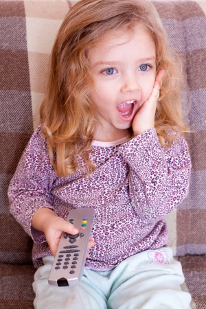 Little girl watching TVの写真素材