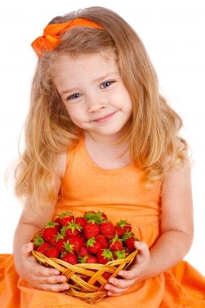 Happy little girl with strawberriesの写真素材