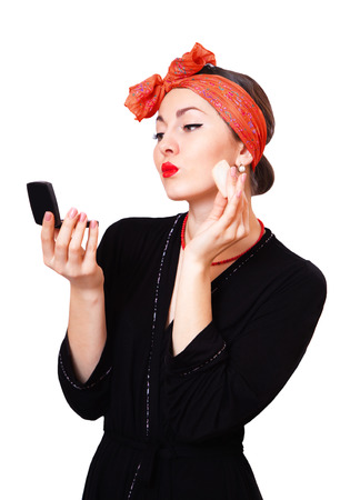 Young beautiful caucasian girl powders face, isolated on whiteの写真素材