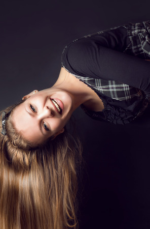 Cheerful woman laughs in the studio on a black backgroundの写真素材