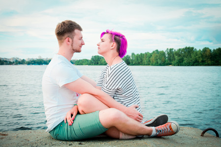 Close up of a young couple visiting at riverの写真素材