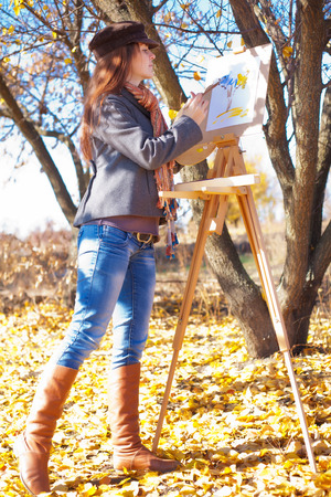 Young woman having fun laughing near easelの写真素材