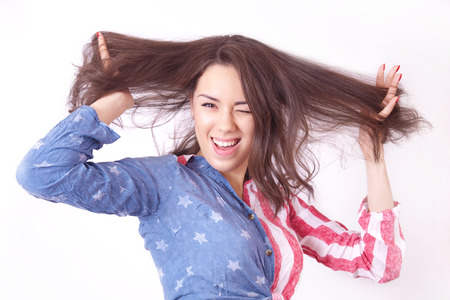 Cheerful smiling girl with unruly brown hairの写真素材