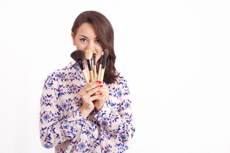 Girl makeup artist with brushes in handの写真素材