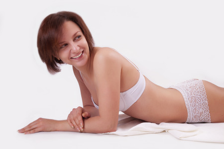 Young girl in lingerie over white backgroundの写真素材