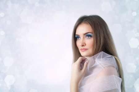 Winter beauty young woman studio portrait on winter backgroundの写真素材