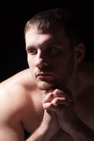 Image of shirtless man keeping his hands by face while thinkingの写真素材