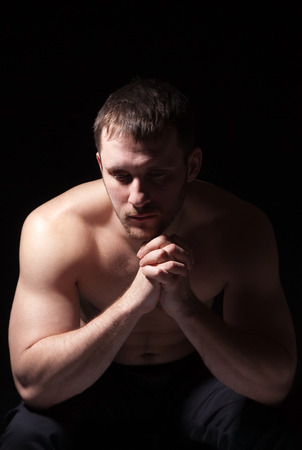 Image of shirtless man keeping his hands by face while thinkingの写真素材