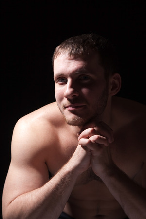 Image of shirtless man keeping his hands by face while thinkingの写真素材