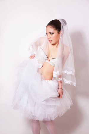 Bride in a skirt, underwear and stockings on gray backgroundの写真素材