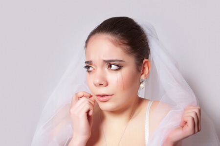 Portrait of a beautiful bride crying hurt closeupの写真素材