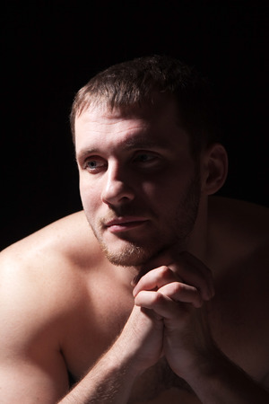 Image of shirtless man keeping his hands by face while thinkingの写真素材