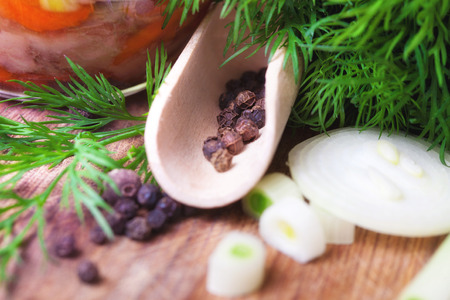 Aromatic herbs, peppers and onions on a table, close-upの写真素材