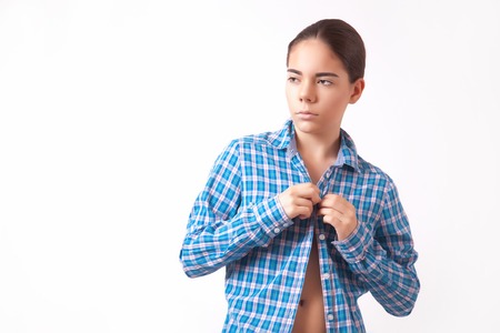 Young woman in a jeans unbuttoned blue shirtの写真素材