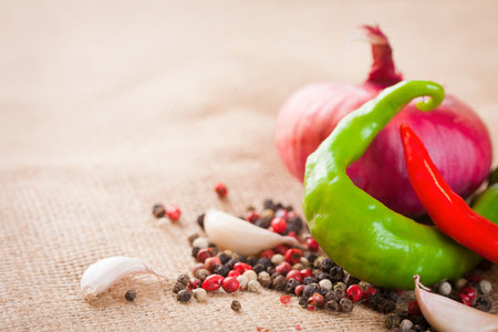 Onions, garlic, chili pepper and spices on the table close-upの写真素材