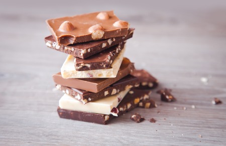 Pieces of chocolate on the wooden tableの写真素材