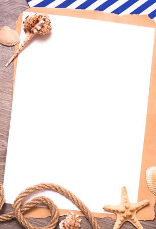 Background with a white sheet of paper, rope and shells in a marine styleの写真素材