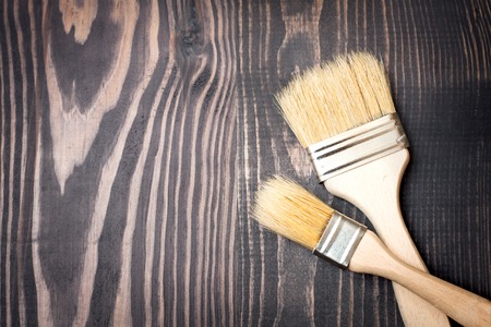 Two paint brushes on old wooden backgroundの写真素材