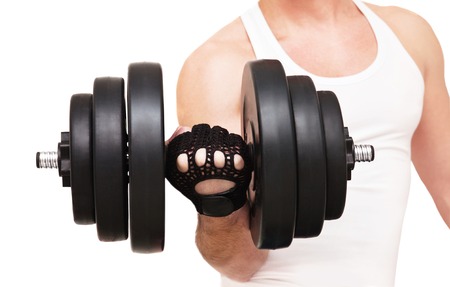 Man in a white T-shirt with a dumbbell in his hand on a white backgroundの写真素材