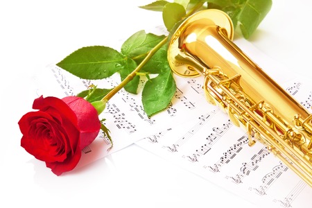 Red rose, saxophone and notes on a white backgroundの写真素材