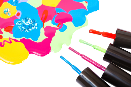 Multi-colored nail polish and brush, isolated on a white backgroundの写真素材
