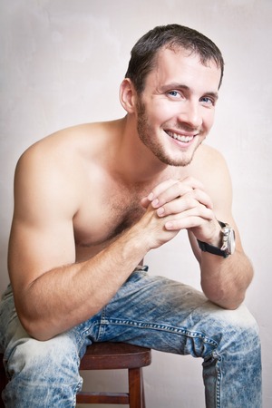 Portrait of thoughtful attractive man close up on a gray backgroundの写真素材