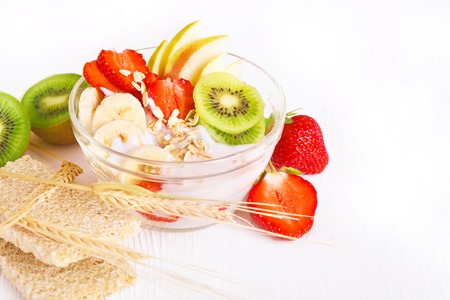 Yogurt with exotic fruits and cereals on a white backgroundの写真素材