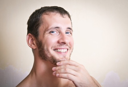 Portrait of thoughtful attractive man close up on a gray backgroundの写真素材