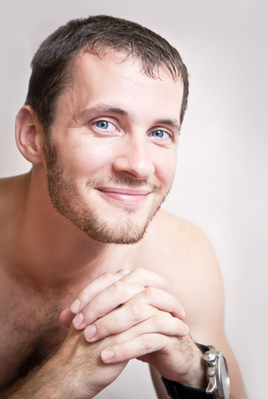 Portrait of happy smiling attractive man close up on a gray backgroundの写真素材