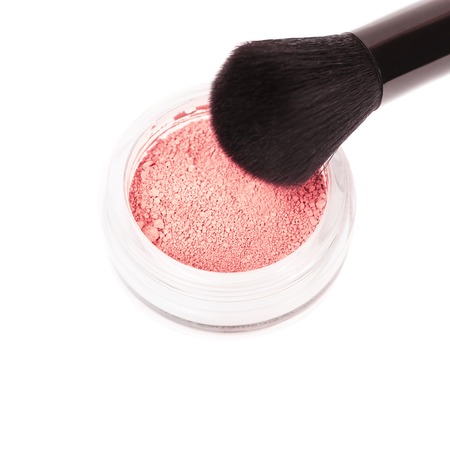 Powder blush and black makeup brush on white backgroundの写真素材