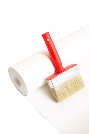 Brush and roll of wallpaper isolated on white backgroundの写真素材